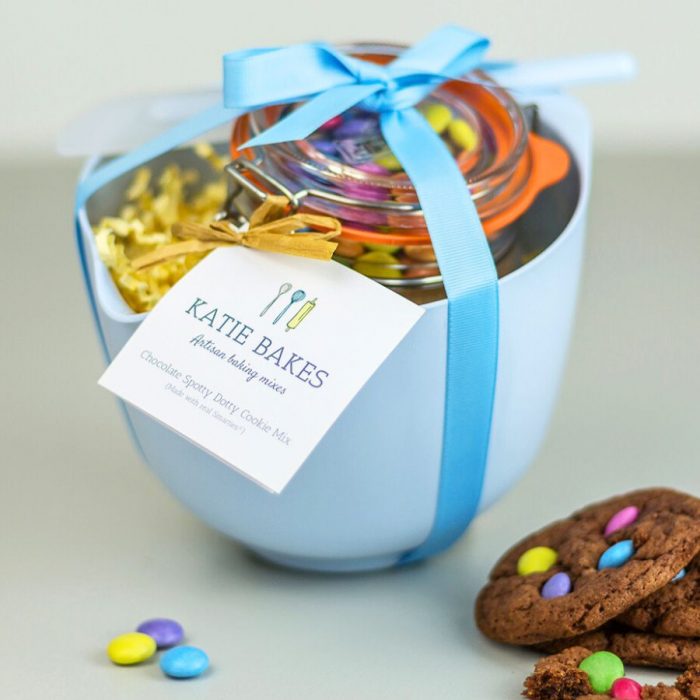 Blue Baking Mix Gift Set with Rosti mixing bowl, mixing spoon and Kilner Jar Baking Mix nestled in the bowl. Everything is tied with ribbon and baked cookies are in the foreground