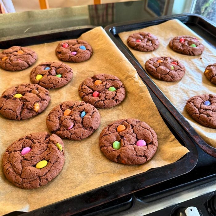 Tray of chocolate spotty dotty cookies topped with colourful Smarties